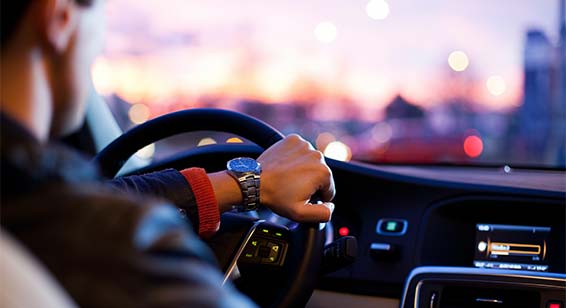 fashionable-man-driving-car-wearing-wrist-watch-backseat-pov-dashboard-uber-driver | NYC Concierge Services by The Personal Helpers