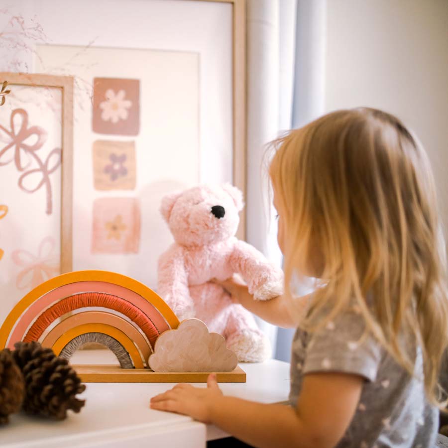 little-girl-putting-her-teddy-bear-where-it-belongs