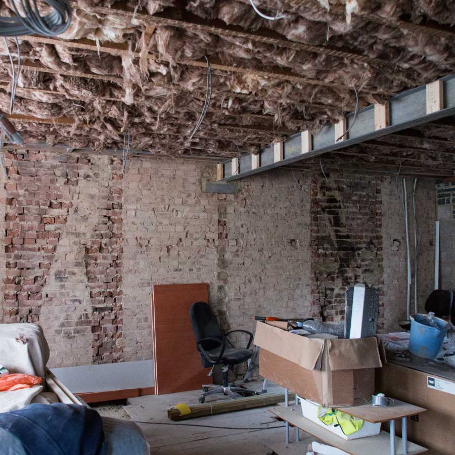 unfinished-basement-with-office-chair-boxes-construction | The Personal Helpers