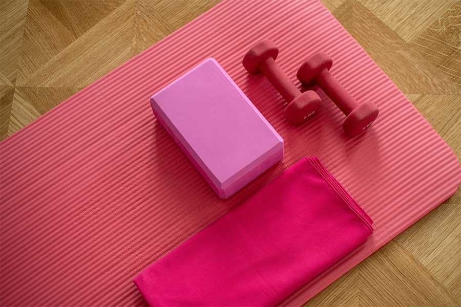 fitness yoga mat block towel red dumbells home gym clutter