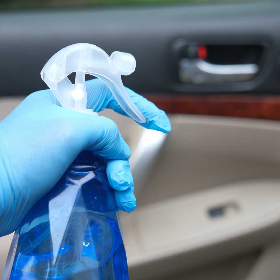 cleaning-car-interior-door-with-spray-bottle
