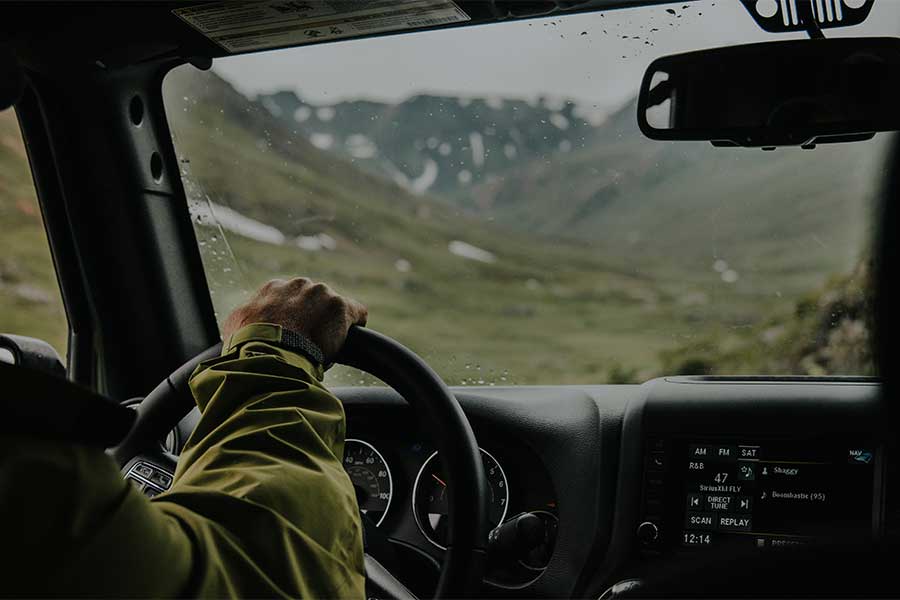 person-driving-car-interior-pov-traveling-hillside-mountain-journey-view