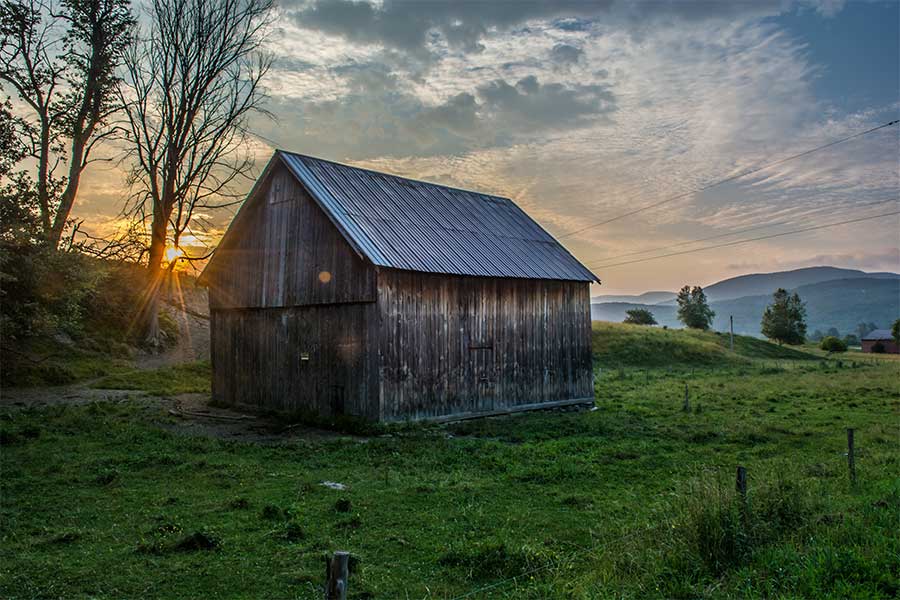 brown-shed-outdoors-sunrise-green-field