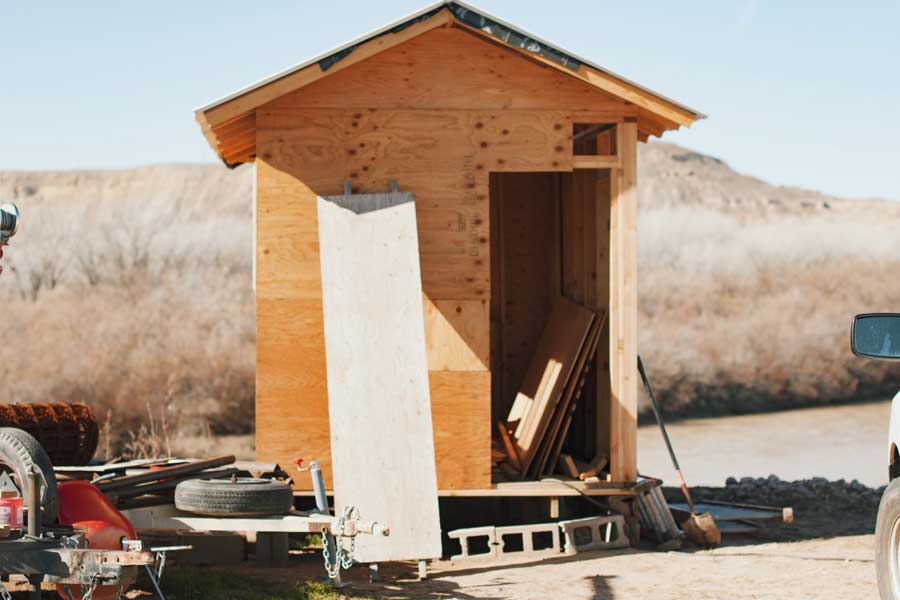 unfinished-shed-outhouse-cluttered-with-tools-construction-materials