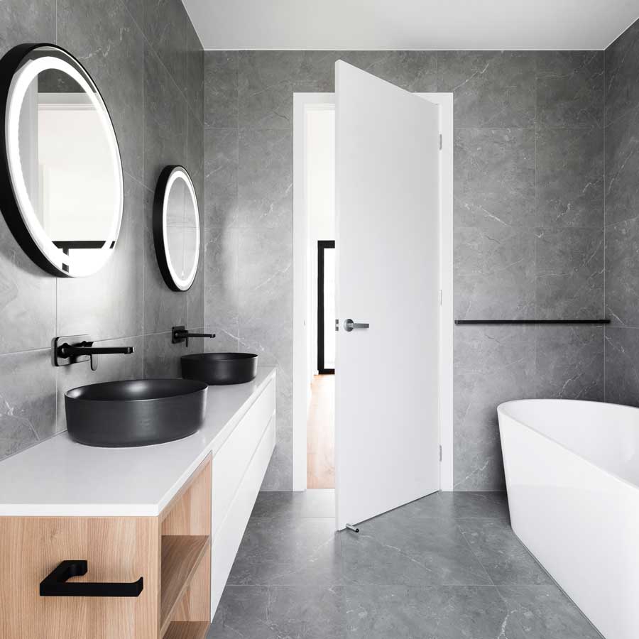 spotless-organized-modern-bathroom-white-countertop-black-sink-gray-marble-floor-white-bathtub