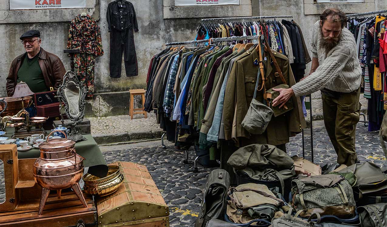 people-shopping-street-fare-old-clothes-on-racks-bags-antiques