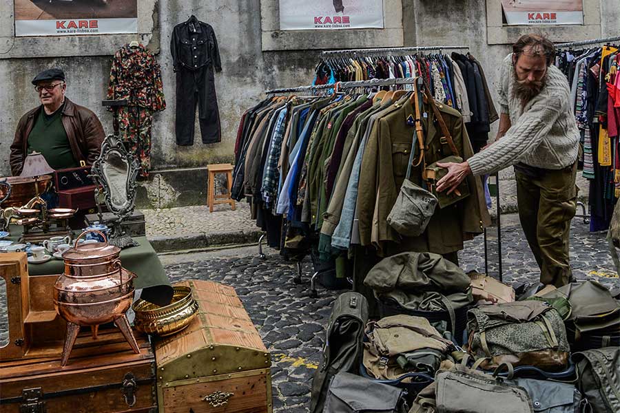 people-shopping-street-fare-old-clothes-on-racks-bags-antiques