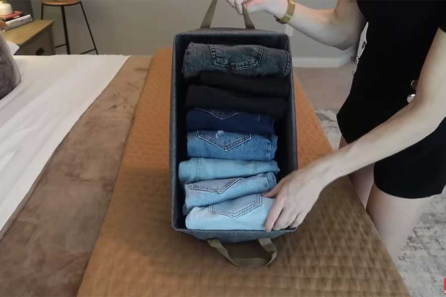Neatly folded jeans in an clothing basket