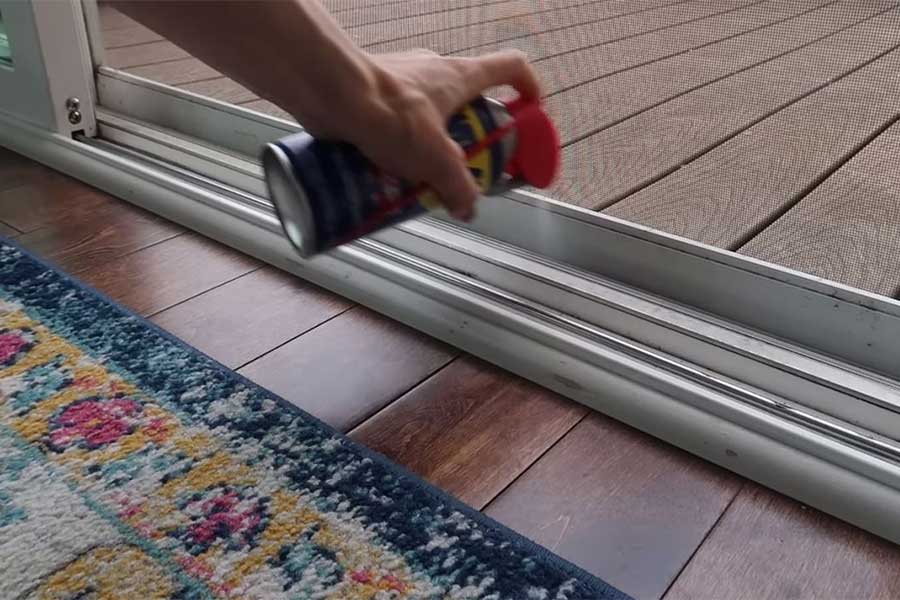 Can of WD-40 being sprayed on door deck areas to deter bugs