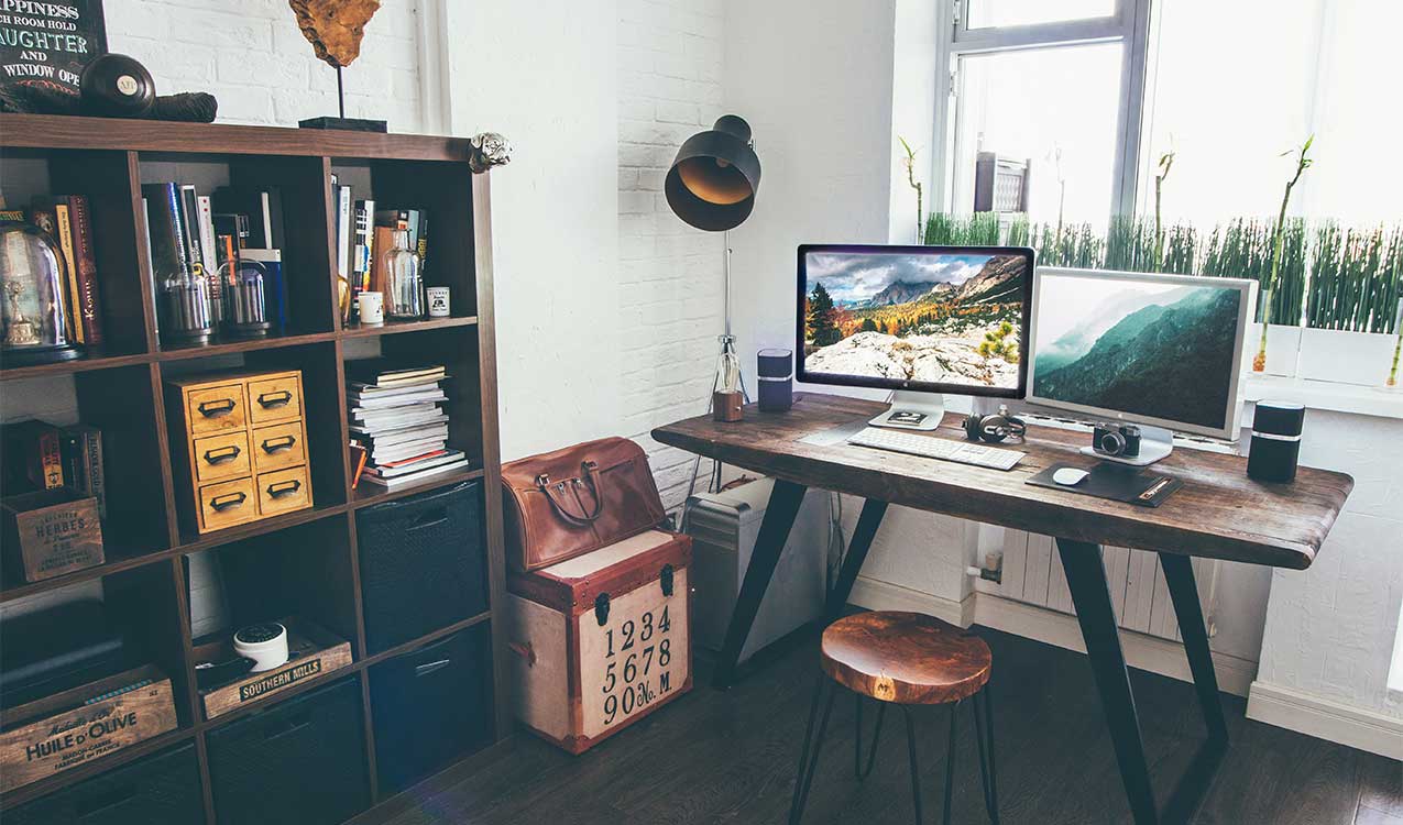 an-organized-office-desk-computer-study-area-with-bookshelf-lamp-trunk-storage