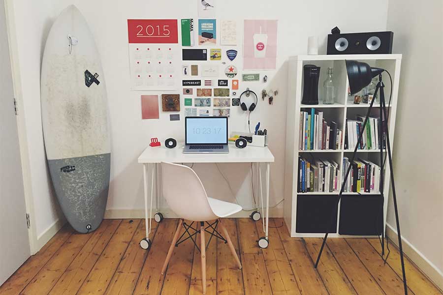 study-area-in-adolenscent-bedroom-desk-computer-surfboard-calendar-bookshelf