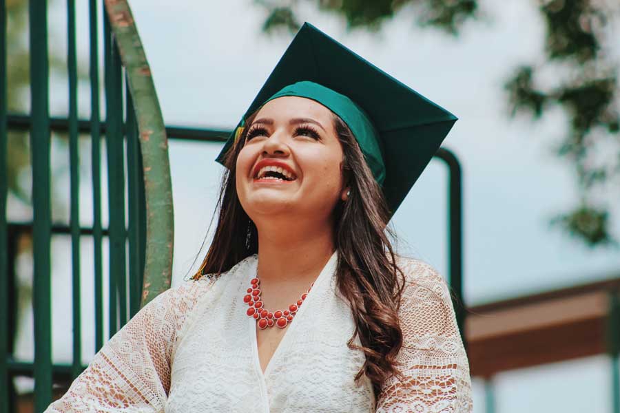 young-woman-with-green-graduation-cap-from-gown